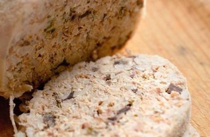 a close-up of a piece of bread on a wooden cutting board.