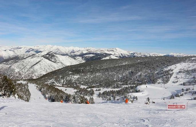 a snow-covered ski slope with a red sign that says welcome